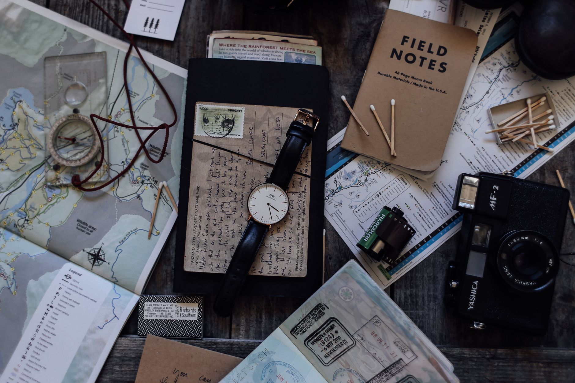 Travel journal and map on wooden table